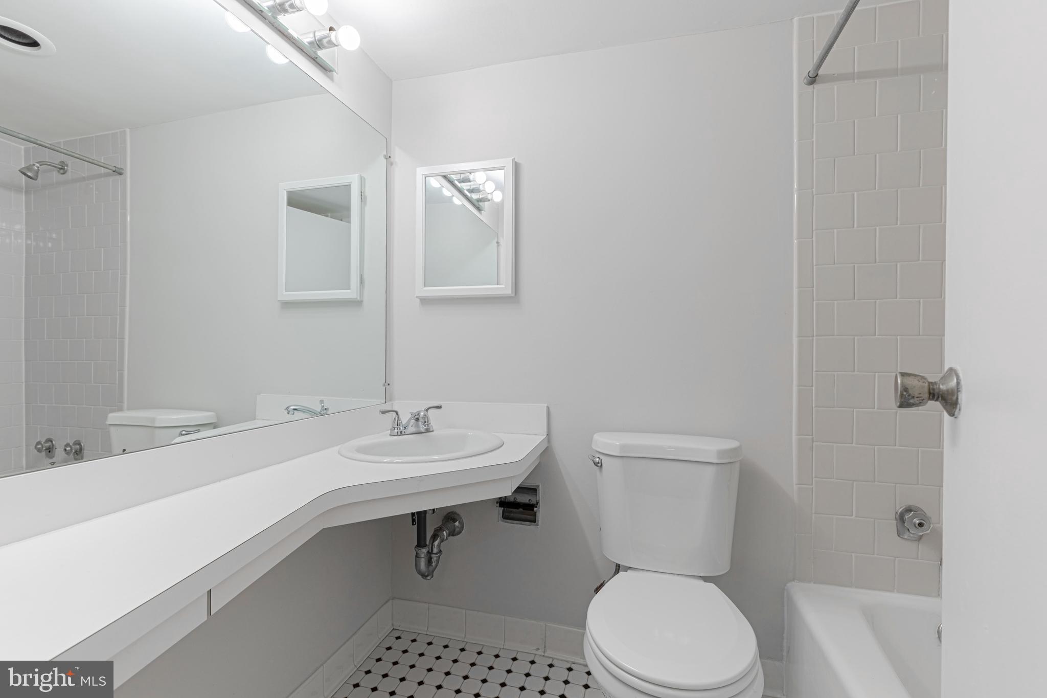950 25th Street Northwest, Unit 327N Washington, DC 20037 - Photo 12 of 29 a bathroom with a sink toilet and shower
