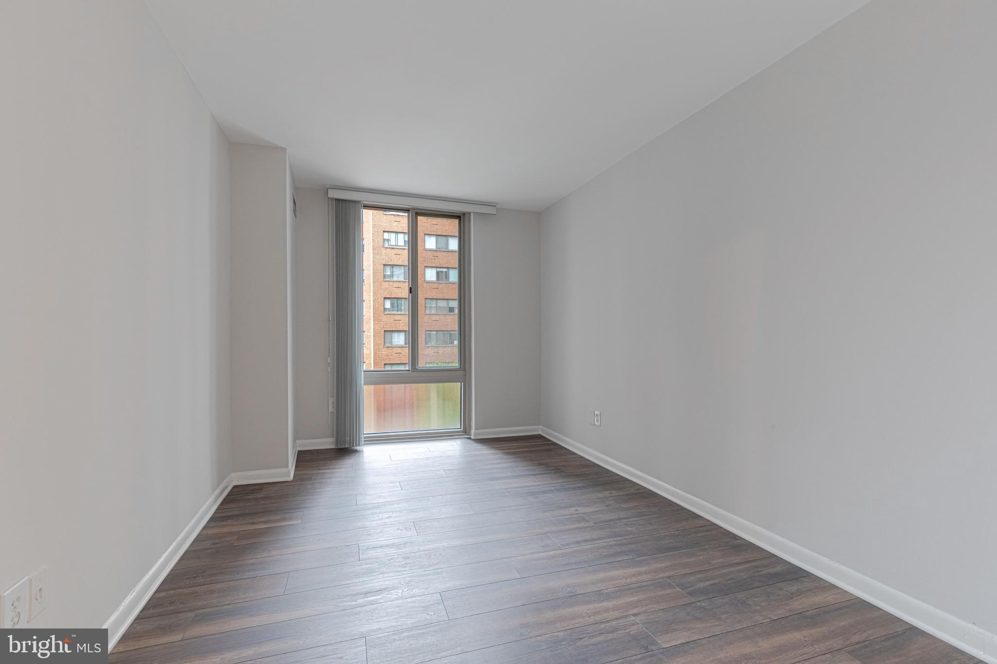 950 25th Street Northwest, Unit 327N Washington, DC 20037 - Photo 13 of 29 a view of an empty room with wooden floor and a window