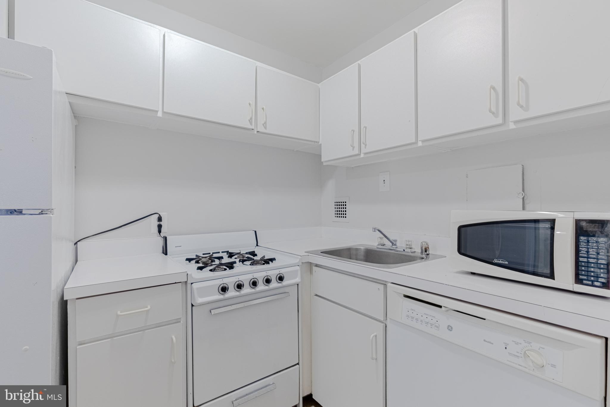 950 25th Street Northwest, Unit 327N Washington, DC 20037 - Photo 6 of 29 a kitchen with appliances a sink and cabinets