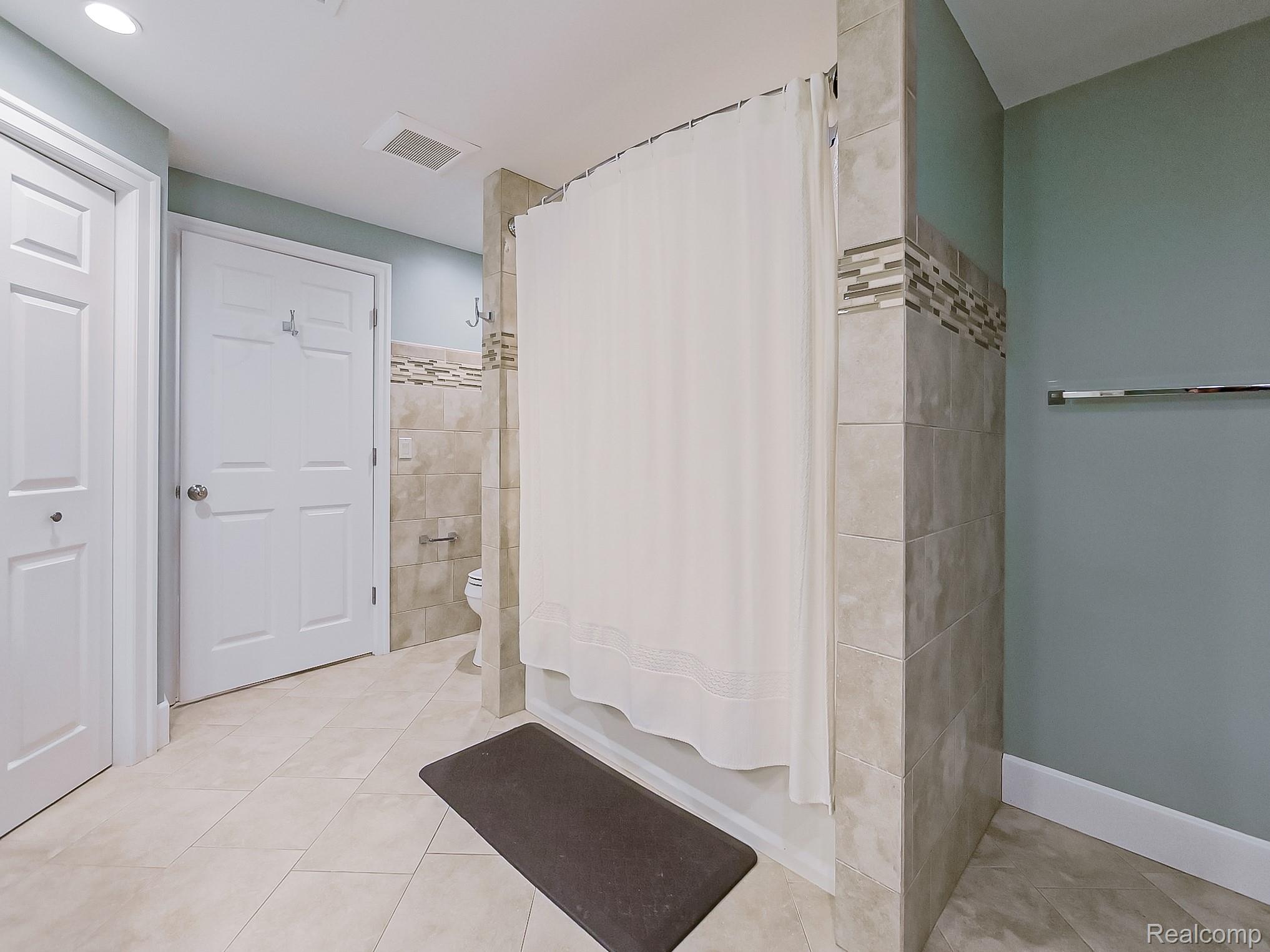 3720 East Clarkston Road Oakland, MI 48363 - Photo 38 of 60 Bathroom with light tile patterned floors and tile walls