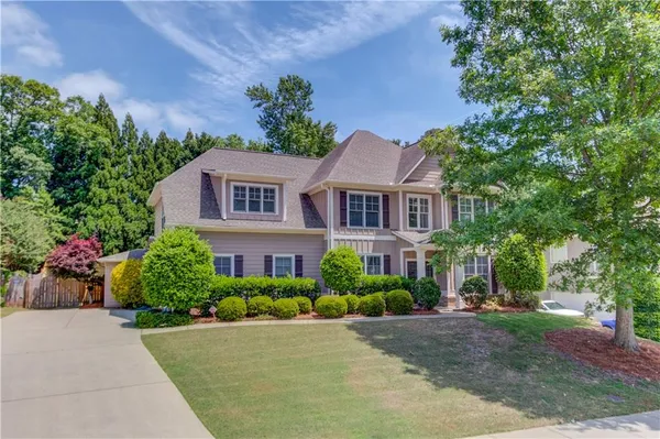 a front view of a house with a yard