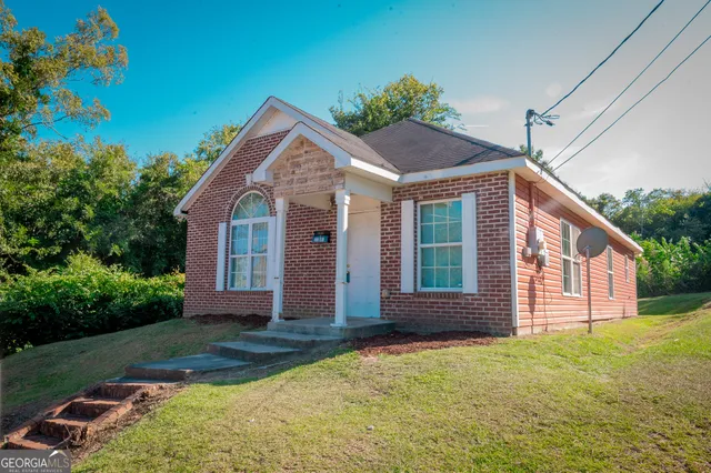 a front view of a house with garden