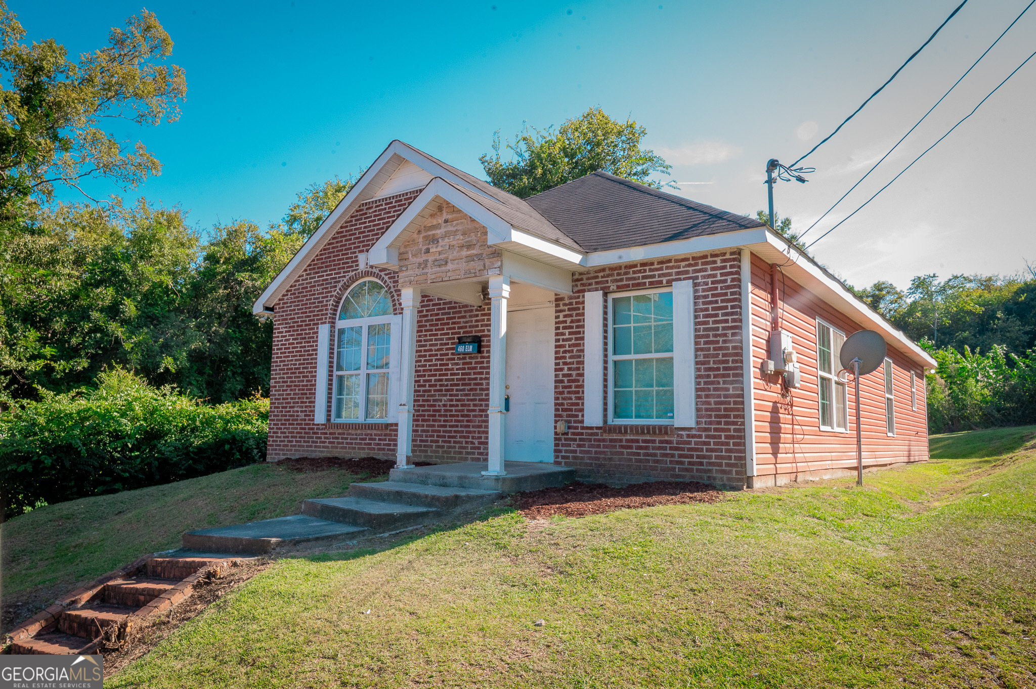 a front view of a house with garden