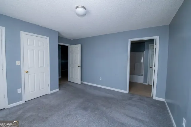 an empty room with closet area