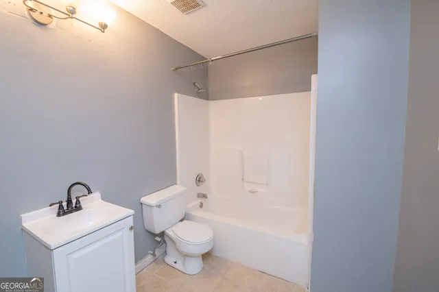 a white toilet sitting next to a bathroom sink