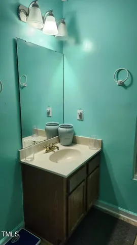 a bathroom with a sink and mirror
