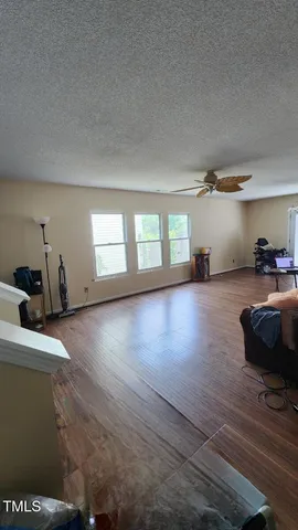 a view of a livingroom with furniture and a window