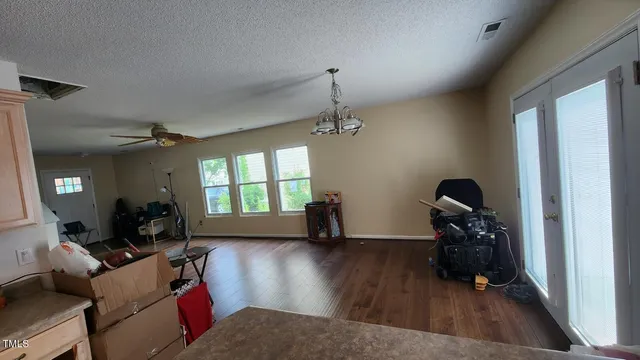 a living room with furniture or wooden floor and a window