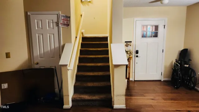 a view of entryway with wooden floor and stairs