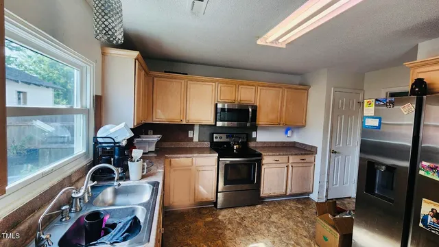 a kitchen with a stove a refrigerator and a stove