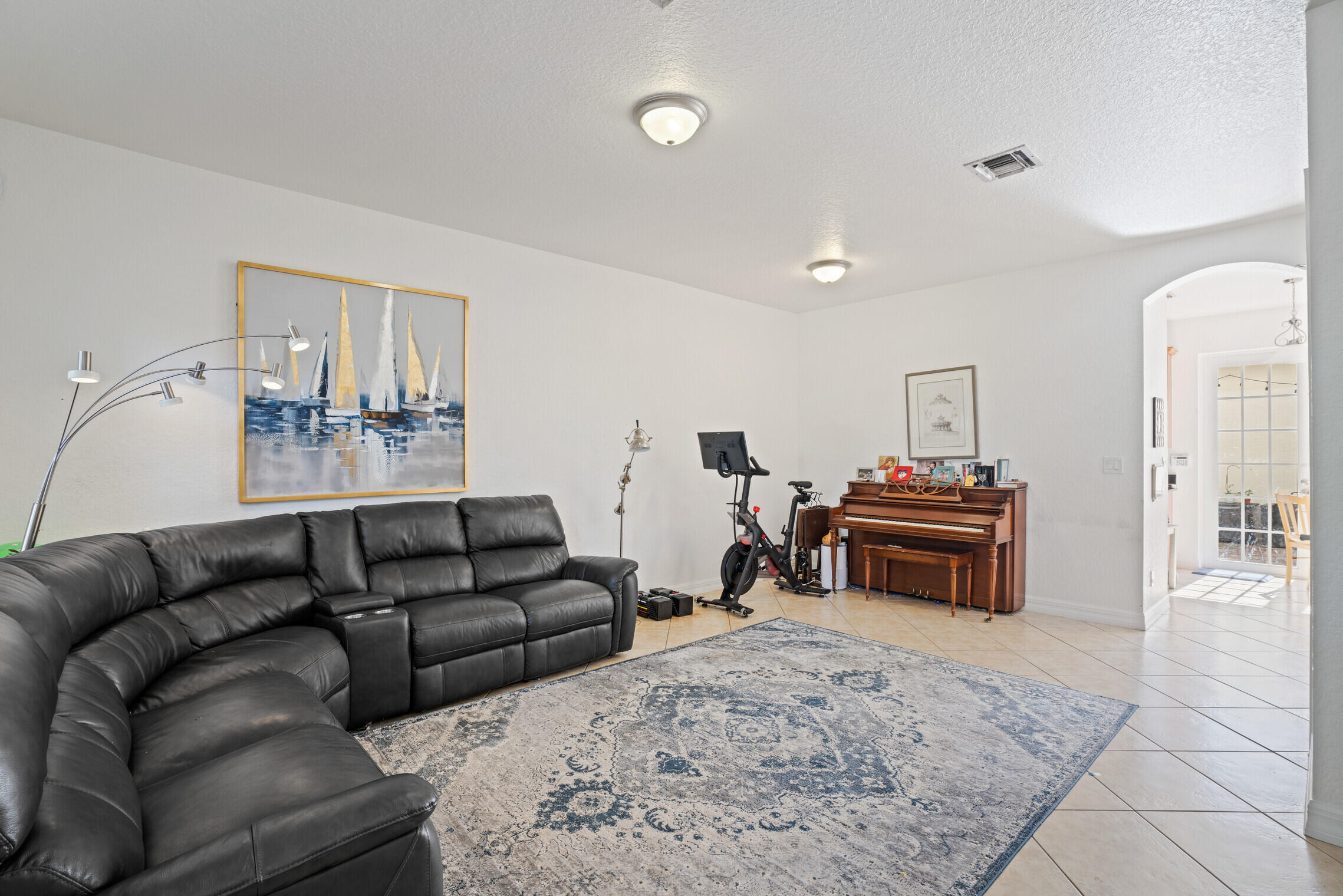 151 Mulligan Place Jupiter, FL 33458 - Photo 4 of 23 a living room with furniture a couch and a fireplace