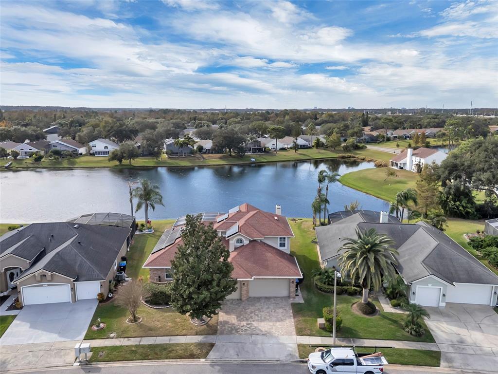 an aerial view of a house with a lake view