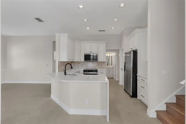 a refrigerator freezer sitting inside of a kitchen
