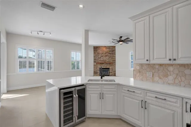 a view of a livingroom with a ceiling fan and window