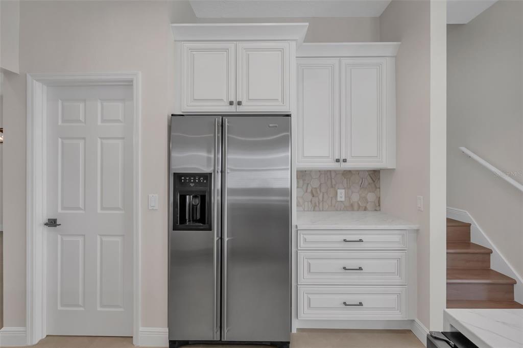 2626 Raccoon Run Lane Orlando, FL 32837 - Photo 21 of 62 a refrigerator freezer sitting inside of a kitchen