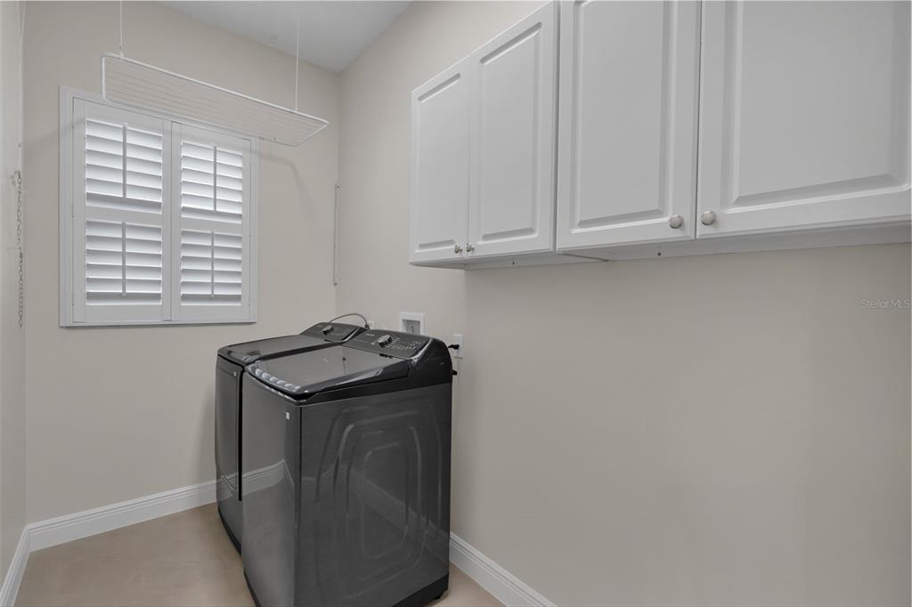 2626 Raccoon Run Lane Orlando, FL 32837 - Photo 22 of 62 a view of storage and utility room with washer and dryer