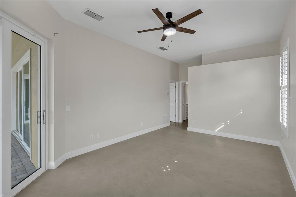 2626 Raccoon Run Lane Orlando, FL 32837 - Photo 25 of 62 an empty room with a ceiling fan and a window
