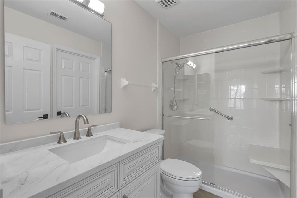 2626 Raccoon Run Lane Orlando, FL 32837 - Photo 34 of 62 a bathroom with a sink a toilet and shower