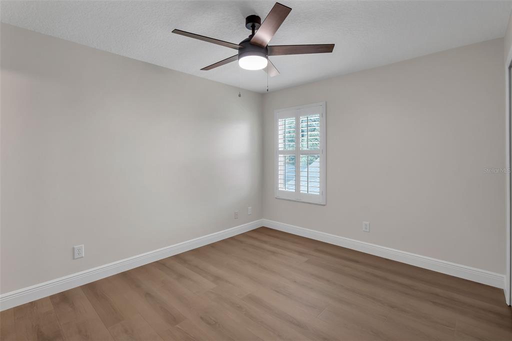 2626 Raccoon Run Lane Orlando, FL 32837 - Photo 35 of 62 an empty room with wooden floor and windows