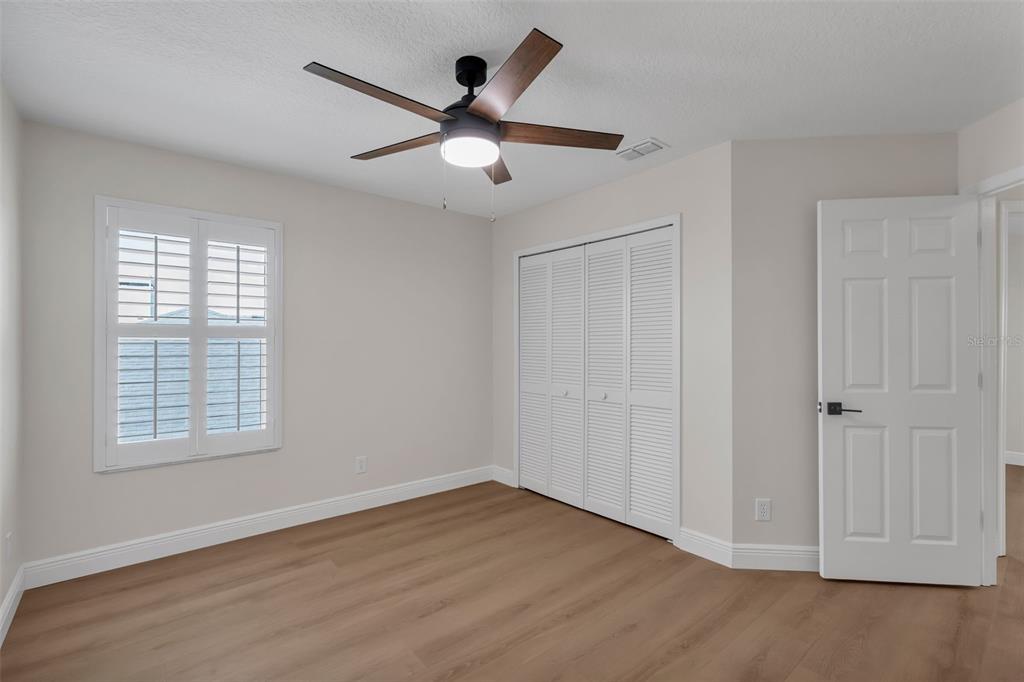 2626 Raccoon Run Lane Orlando, FL 32837 - Photo 36 of 62 wooden floor in an empty room with a window