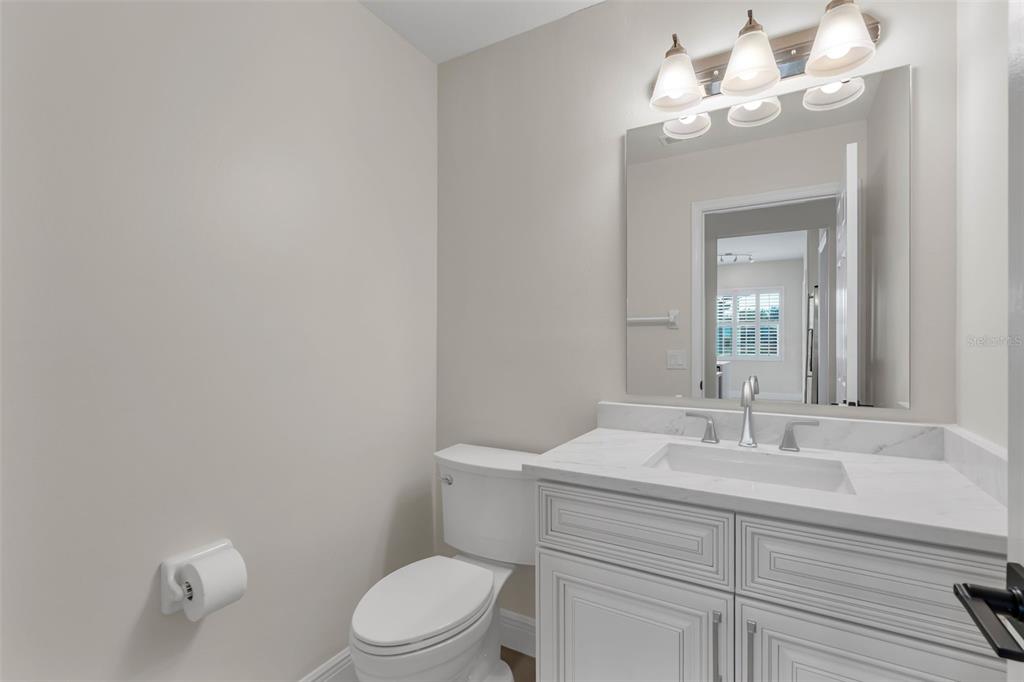 2626 Raccoon Run Lane Orlando, FL 32837 - Photo 37 of 62 a bathroom with a sink a toilet and a mirror