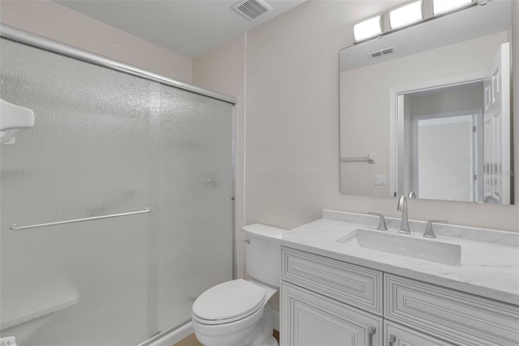 2626 Raccoon Run Lane Orlando, FL 32837 - Photo 40 of 62 a bathroom with a sink a toilet and a mirror
