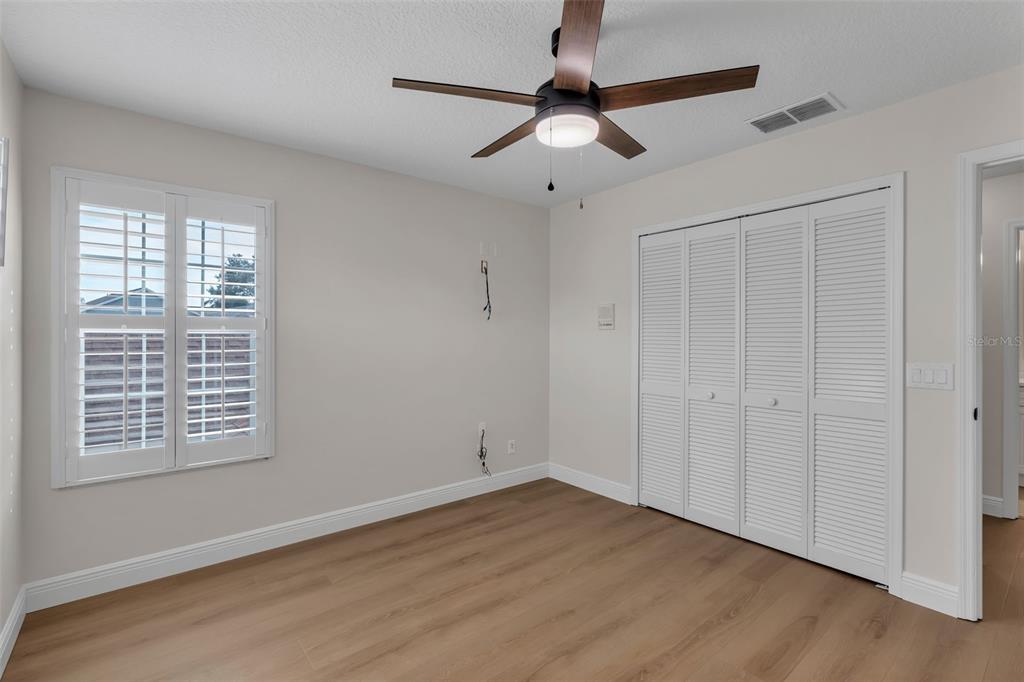 2626 Raccoon Run Lane Orlando, FL 32837 - Photo 42 of 62 a view of an empty room with a window and wooden floor