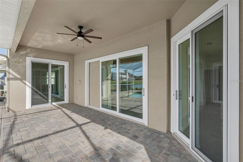 2626 Raccoon Run Lane Orlando, FL 32837 - Photo 43 of 62 a living room with a large window and a chandelier fan