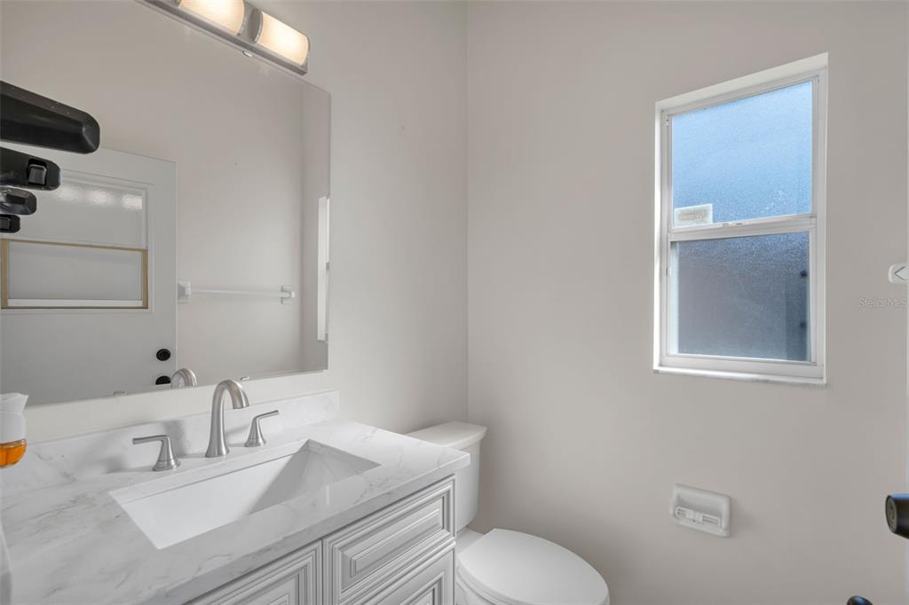 2626 Raccoon Run Lane Orlando, FL 32837 - Photo 45 of 62 a bathroom with a sink vanity mirror and toilet