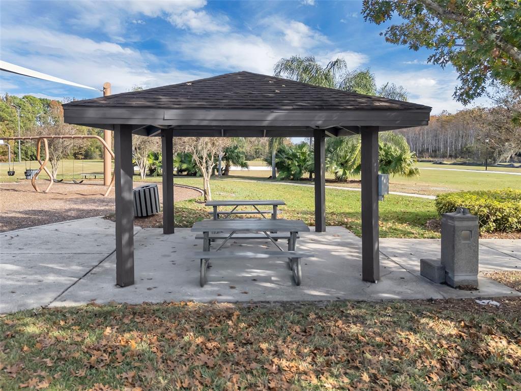 2626 Raccoon Run Lane Orlando, FL 32837 - Photo 53 of 62 a view of a patio with a table chairs and a floor to ceiling window
