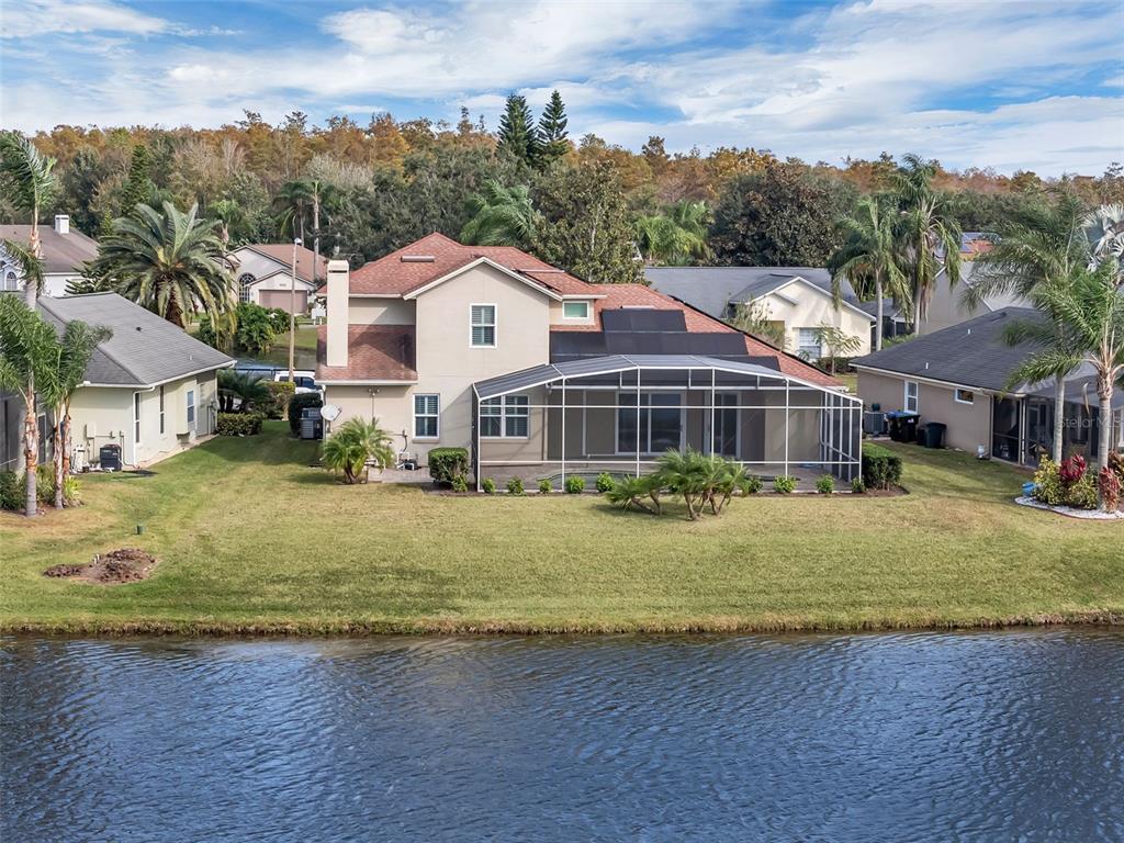 2626 Raccoon Run Lane Orlando, FL 32837 - Photo 7 of 62 a front view of a house with a garden and yard