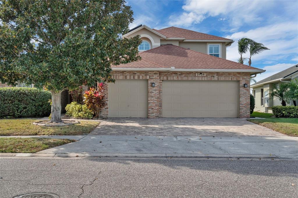 2626 Raccoon Run Lane Orlando, FL 32837 - Photo 8 of 62 a view of a house with a yard and garage