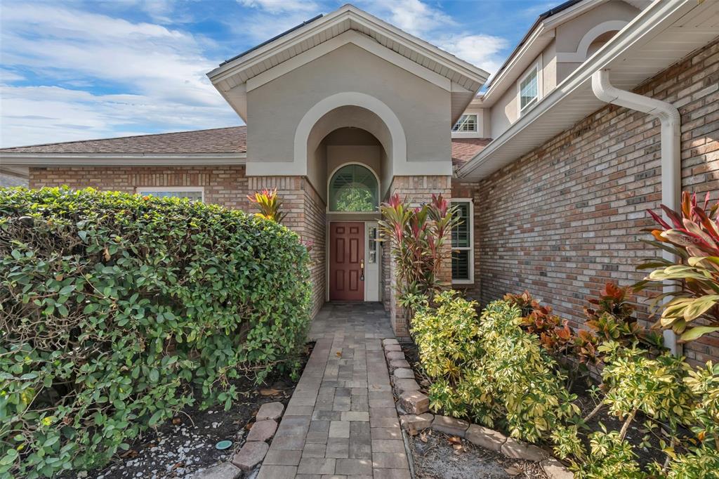2626 Raccoon Run Lane Orlando, FL 32837 - Photo 9 of 62 a front view of a house with a garden