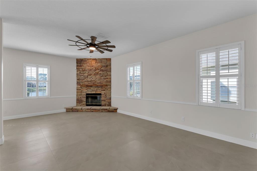 2626 Raccoon Run Lane Orlando, FL 32837 - Photo 10 of 62 an empty room with windows and fireplace