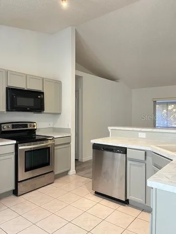 a kitchen with a stove and a microwave