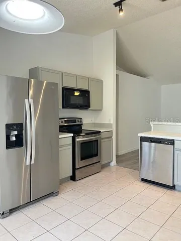 a kitchen with stainless steel appliances a refrigerator stove and microwave