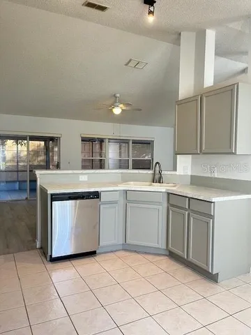 a kitchen with stainless steel appliances granite countertop a sink and cabinets