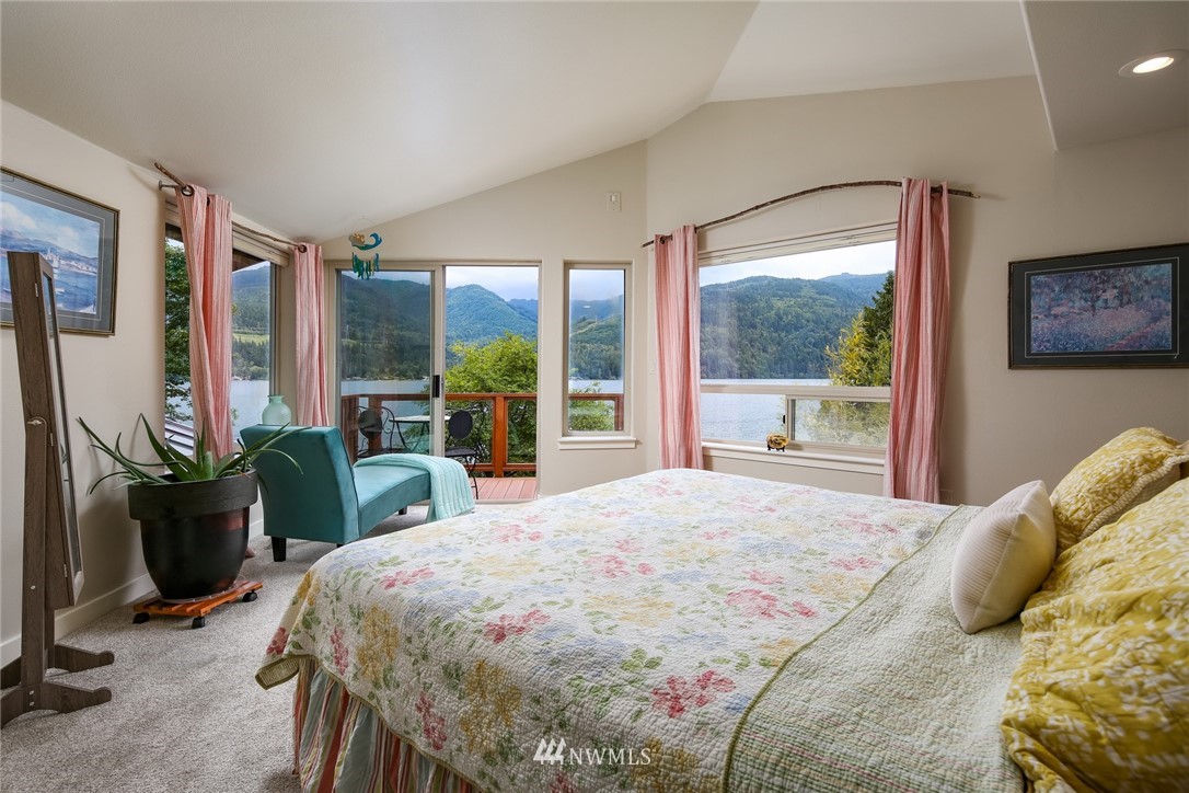 8 Inlet Circle Bellingham, WA 98229 - Photo 15 of 39 a bedroom with a bed flat screen tv and a large window