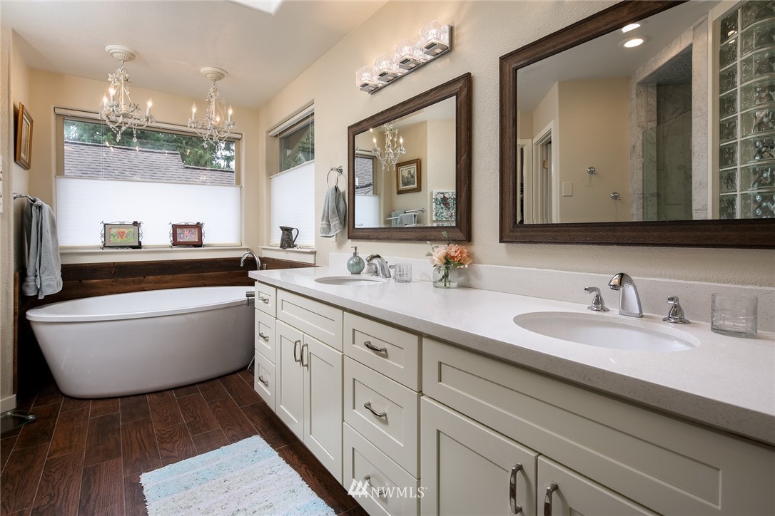 8 Inlet Circle Bellingham, WA 98229 - Photo 17 of 39 a bathroom with double vanity sinks a toilet a mirror and a window