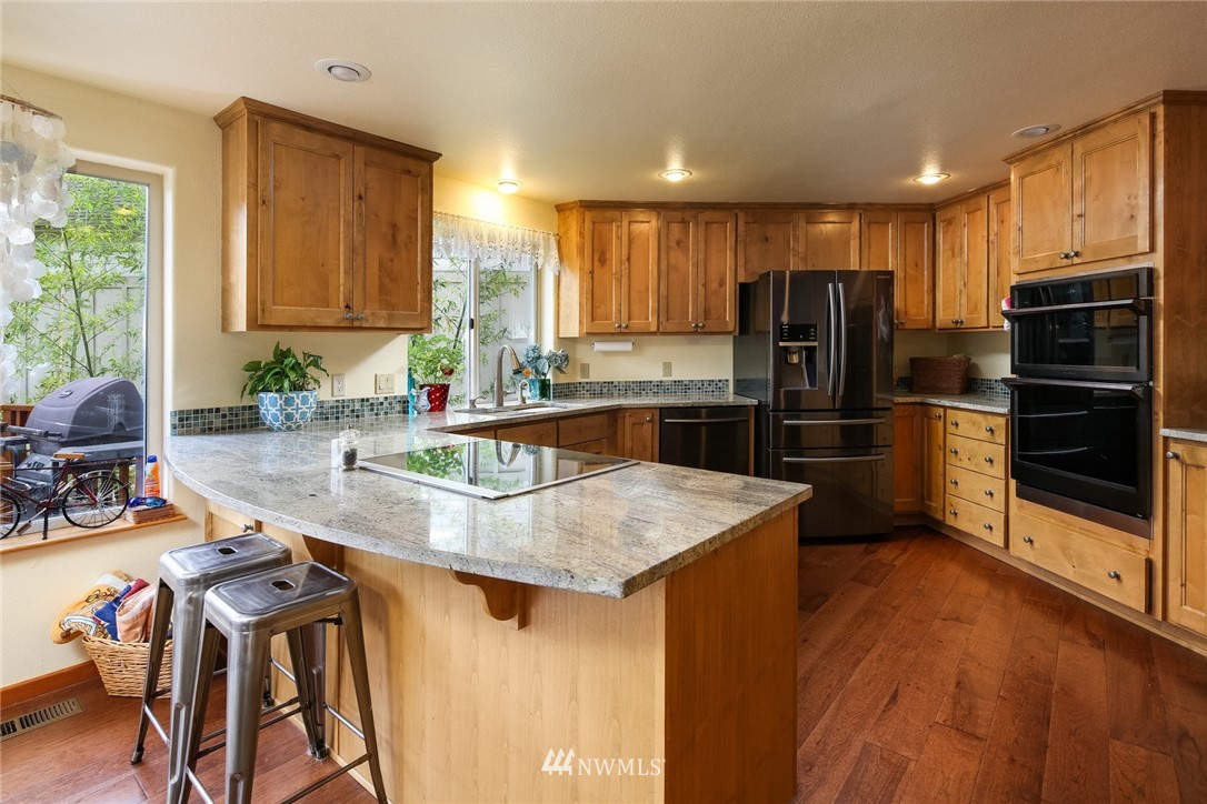 8 Inlet Circle Bellingham, WA 98229 - Photo 10 of 39 a kitchen with kitchen island a large counter top space appliances and a window