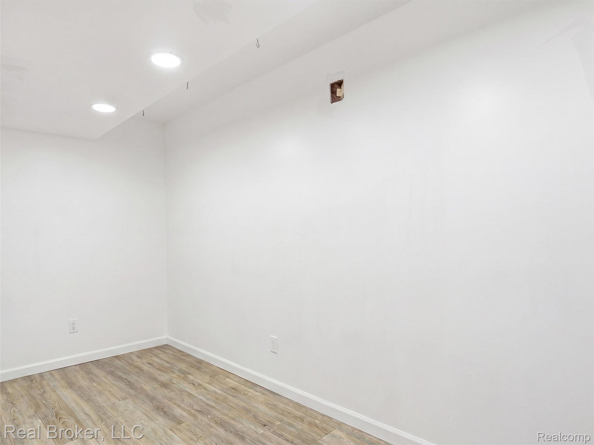 7271 West Ray Road Gaines, MI 48436 - Photo 46 of 48 Room featuring neutral white walls, recessed ceiling lighting, and wood-finish flooring