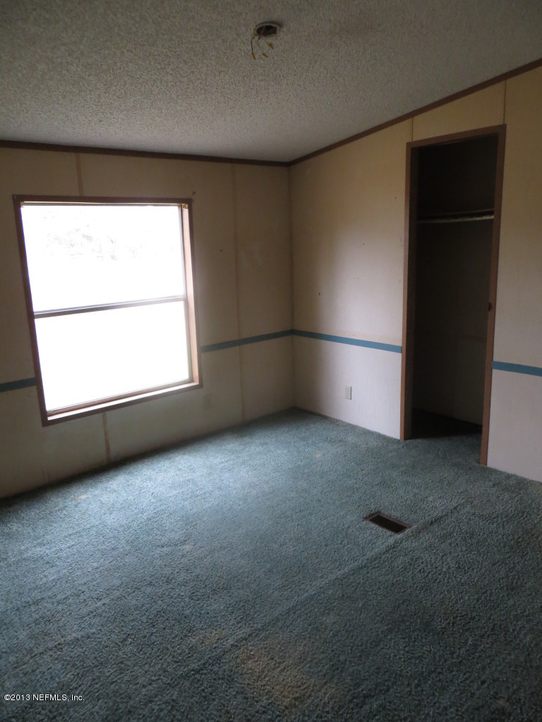 4082 Bronco Road Middleburg, FL 32068 - Photo 7 of 17 an empty room with a empty space and windows