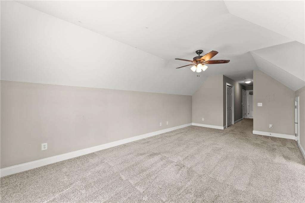 6643 Windvane Point Clermont, GA 30527 - Photo 44 of 88 an empty room with a chandelier fan and window