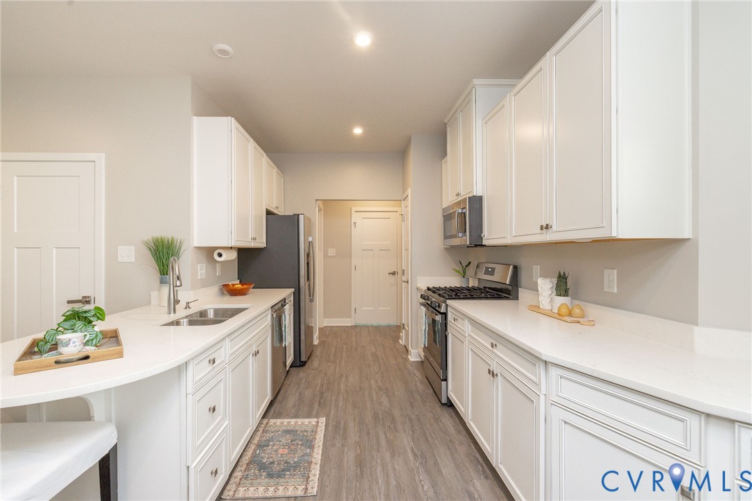 9081 Spring Green Loop Mechanicsville, VA 23116 - Photo 3 of 49 a kitchen with a sink stove cabinets and refrigerator