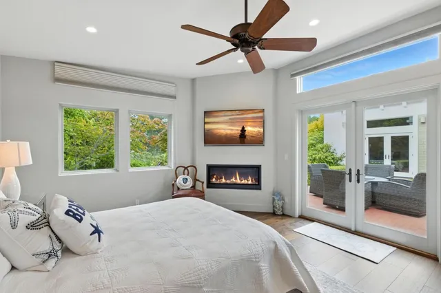 a bedroom with a bed and a large window