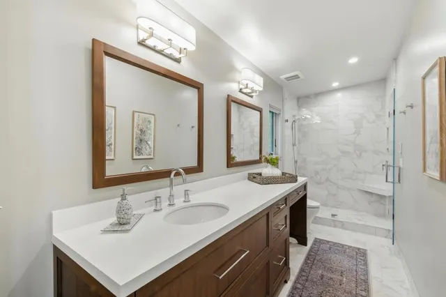 a bathroom with a sink double vanity and a mirror