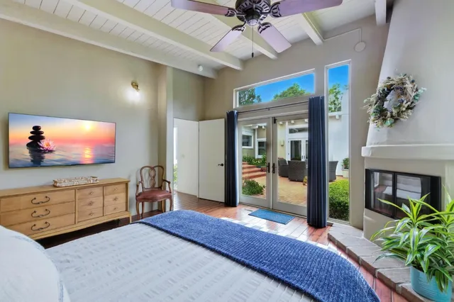 a bedroom with furniture and a flat screen tv