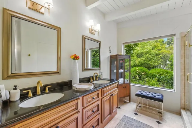 a bathroom with double vanity sinks and a mirror