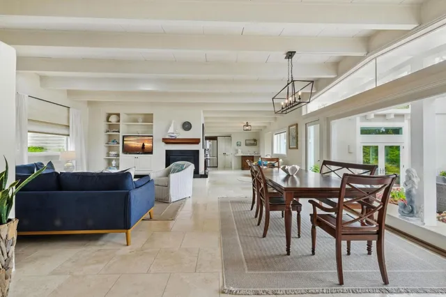 a living room with furniture a window and a chandelier