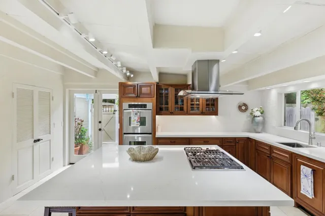 a kitchen with stainless steel appliances granite countertop a sink and cabinets